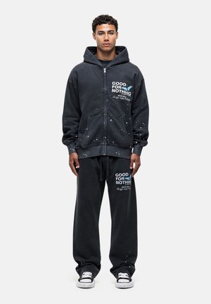 PAINT WASH - Tracksuit bottoms - black