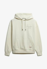 Hoodie crème en tissu doux, avec une poche sur le devant, des cordons de serrage et un logo imprimé sur la poitrine.