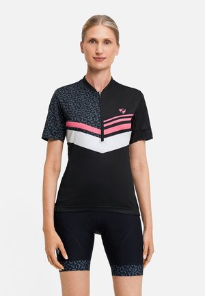 Woman wearing black and pink short-sleeve cycling jersey with leopard print and matching black cycling shorts with leopard print edging.