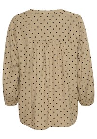 Beige blouse met lange mouwen en zwarte stippen, ronde halslijn, geraffineerde achterkant en elastische manchetten. Zachte stof met een relaxte pasvorm.