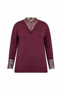 Burgundska majica dugih rukava s čipkastim visokim ovratnikom i čipkastim detaljima na manžetama, izrađena od mekog materijala. Ukupno glatka tekstura.