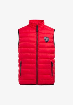 Red padded vest with high collar, full front zipper, two side pockets, and a black accent along the sleeves. Features a logo patch on the chest.