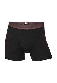 Svarta bomullskompressionsbyxor med en enhetlig design, med en kontrasterande bordeauxfärgad resårmidja märkt "JBS UNDERWEAR."