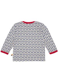 Maglia a maniche lunghe di colore crema con motivo a scimmie blu ripetuto, colletto e polsini rossi. Materiale in cotone morbido, etichetta al lato.