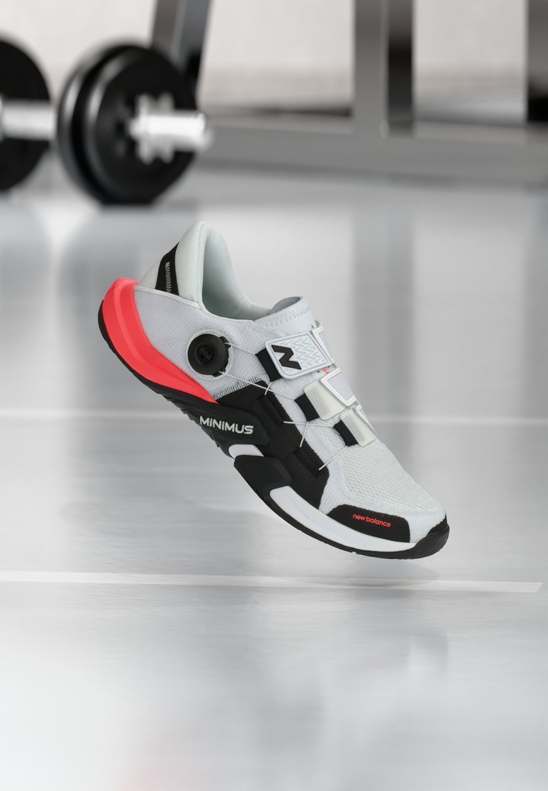 Light gray athletic shoe with black and pink accents, mesh upper, and BOA lacing system. Features "MINIMUS" branding on the side.