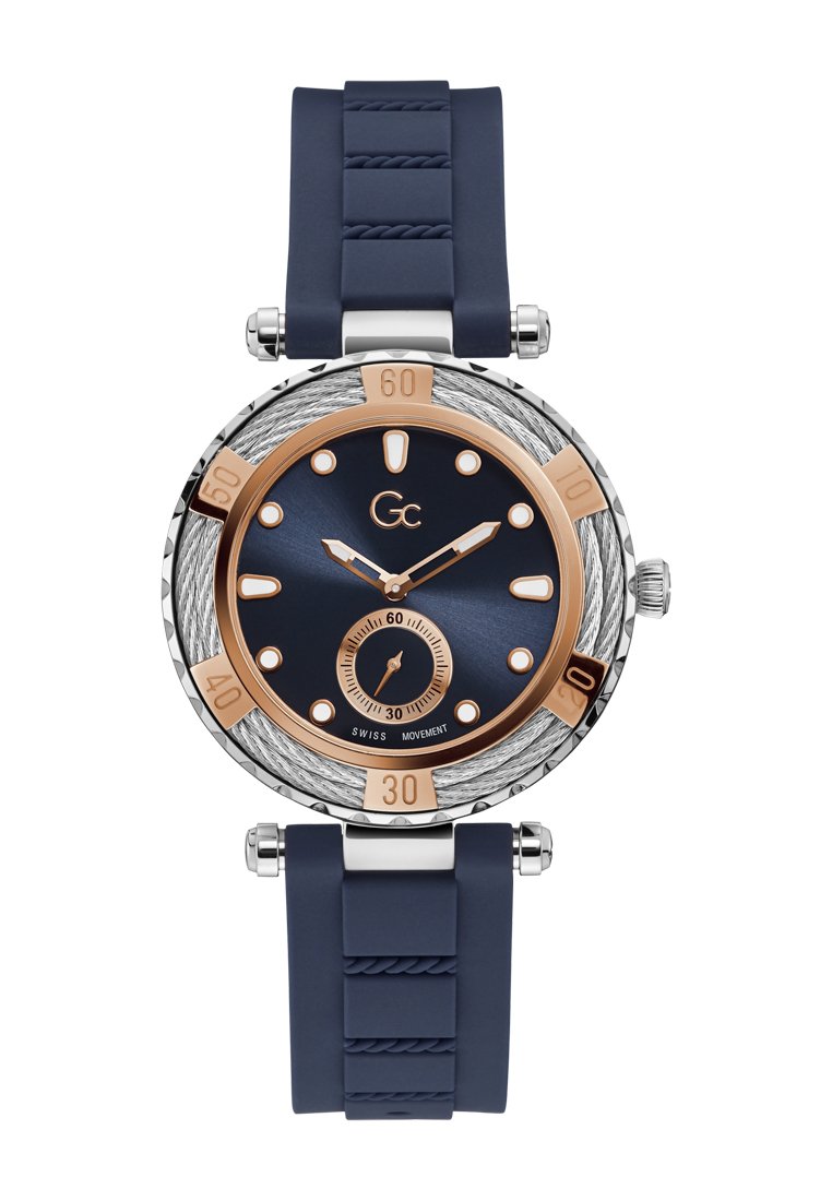 Marinblå silikonarmbandsur med ett hus i rostfritt stål, en mörkblå urtavla, roséguldiga accenter och en strukturerad bezel med minutmarkeringar.