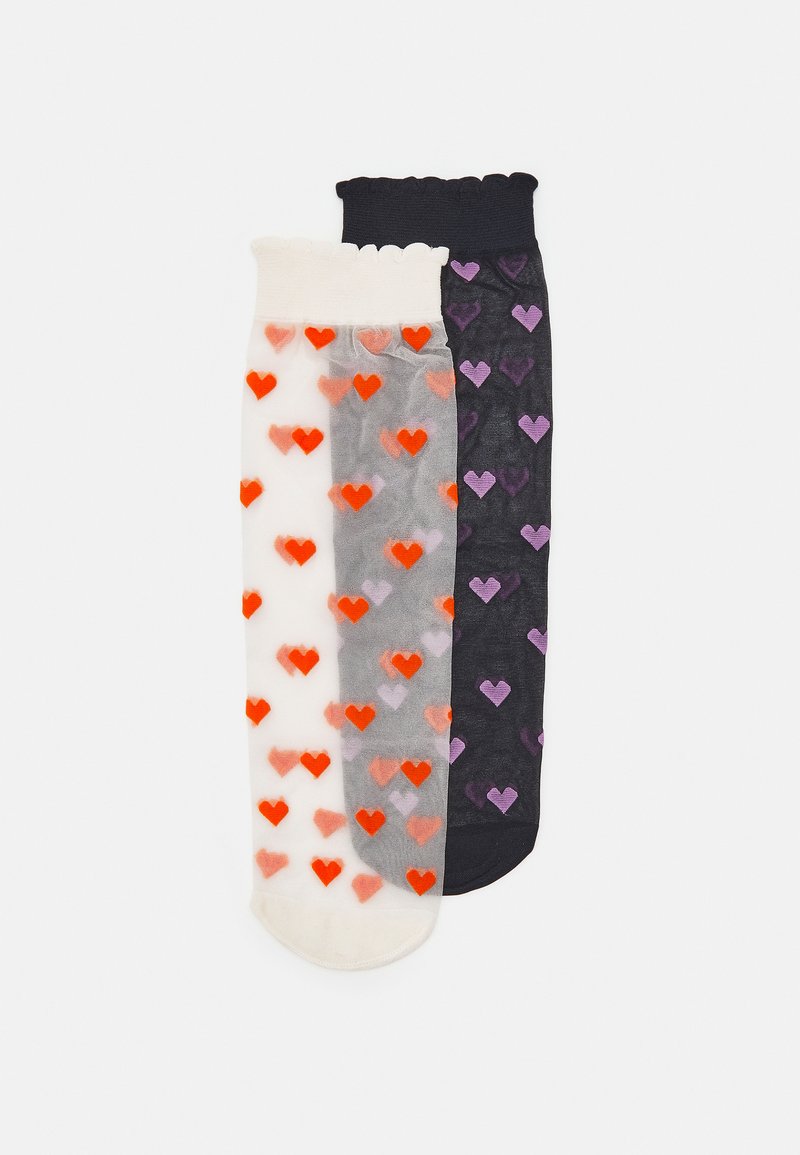 Set of three knee-high socks: one white with orange hearts, one gray with red hearts, and one black with purple hearts. Sheer material.