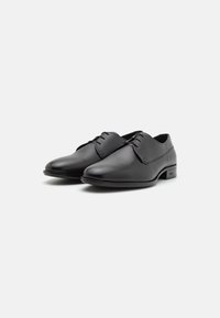 Black leather dress shoes with a smooth finish, rounded toes, and lace-up design. Features subtle textural detail on the vamp.