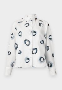 Bílá košile s dlouhým rukávem a abstraktním kruhovým potiskem v odstínech modré a černé. Vyrobeno z bavlny s hladkou texturou.