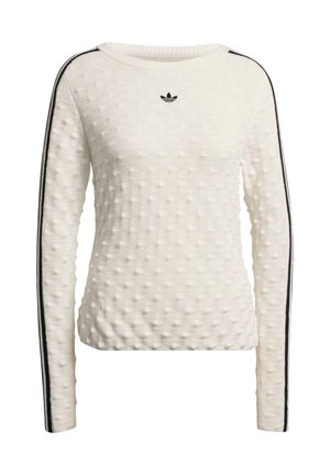 Bijeli džemper s teksturom, okruglim izrezom, dugim rukavima i crnim bočnim prugama. Mali crni logotip sprijeda.