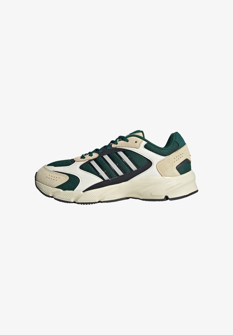 Adidas superge z zgornjim delom iz mrežaste tkanine v temno zeleni barvi, s kremnimi in črnimi poudarki; tri bele črte na strani in strukturiran podplat.