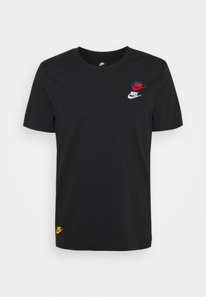 T-shirt noir à manches courtes de Nike avec trois petits logos Nike en bleu, rouge et blanc sur la poitrine, et un logo jaune près de l'ourlet.