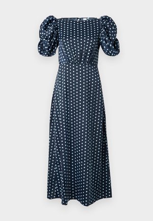 Tumesininen kleit puffvarrukatega, millel on hele sinise täpikujundus. Lõdvalt langev, keskmise pikkusega siluett, millel on vormiv ülakeha.