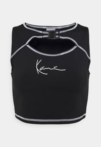 Svart sportcrop top med rund hals, med grå kontrastsömmar och en signaturlogotyp i vitt på framsidan.