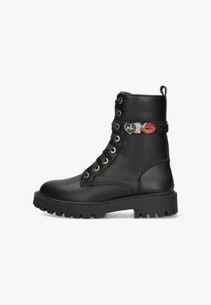 Black leather ankle boot with a rounded toe, metal hardware accents, and textured laces. Chunky rubber sole for added grip and durability.