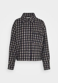 Chemise en flanelle à carreaux bleu marine et beige avec un col, fermeture à deux boutons et une poche poitrine. Design court avec des manches longues.