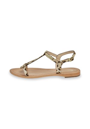 Sandalo piatto con cinturini a stampa animale, soletta in pelle color beige e design minimalista. Presenta una cinghia alla caviglia con dettaglio della fibbia in oro.