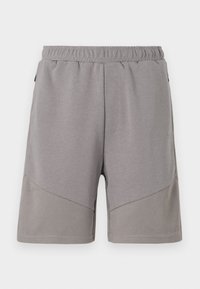 Shorts de sport grises avec une taille élastique, présentant un panneau inférieur texturé et une section supérieure lisse.