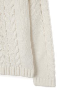 Knit sweater in cream color, featuring a cable pattern on the sides, ribbed hem, and textured fabric for warmth and comfort.