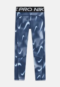 Sötétkék leggings elasztikus anyagból, hullámos fehér mintával, fekete derékpánttal, amelyen a "PRO NIKE" felirat található, és testhezálló fazonnal.