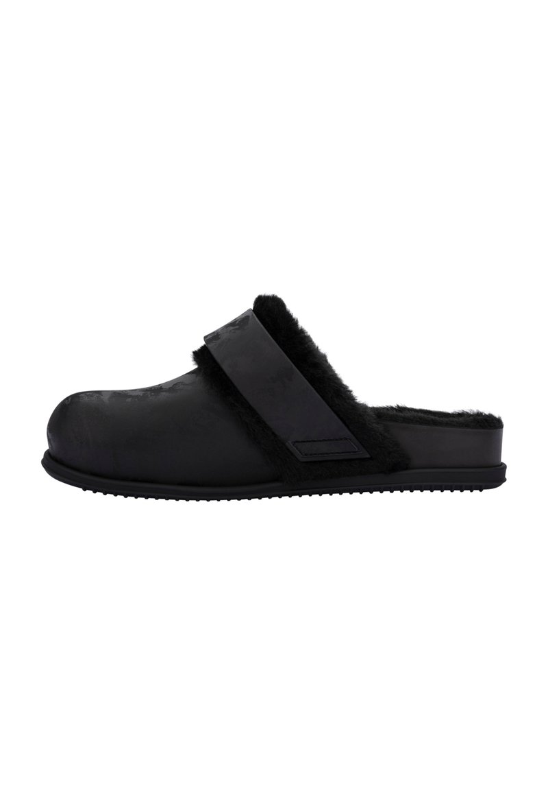 Black clogs feature a soft, fuzzy lining, smooth exterior, and a wide strap across the top. Textured sole provides grip.