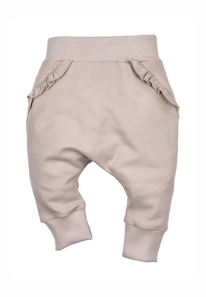 Beige katoenen peuterbroekjes met een geribbelde tailleband en manchetten. Beschikt over ruches aan de zijkanten van de zakken voor extra detail.