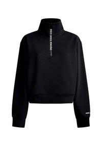 Črna majica z dolgimi rokavi in visokim ovratnikom z zadrgo, označena z napisom "RED BULL RACING" ter majhnim belim napisom "PEPE" na levem manšetnem delu.