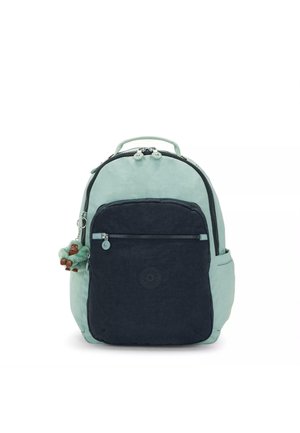 Zaino con parte superiore di un verde menta chiaro, tasca frontale blu navy scuro, chiusura con zip e un portachiavi a pompon verde. Tessuto resistente con una superficie liscia.
