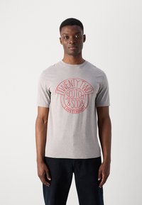 Gray cotton t-shirt featuring a circular red graphic with text "TWENTY TWO SCOTCH & SODA AMSTERDAM" in a casual design. Short sleeves.