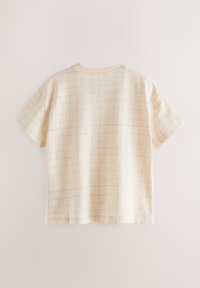 Kortærmet, lysegul skjorte med et ternet mønster i blå, lavet af blødt stof. Har rund halsudskæring og afslappet pasform.