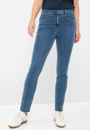 Jeans skinny in denim blu medio. Presentano una vita con bottone in metallo, tasche anteriori e una consistenza liscia con una leggera scoloritura.