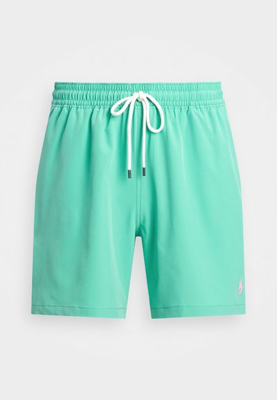 Calções de banho verde menta com um cós elástico, cordão branco e um pequeno logótipo rosa no lado esquerdo da frente. Textura suave.