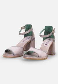 Open-toe heeled sandals in muted lavender and mint green, featuring a block heel, ankle strap, and smooth leather texture.