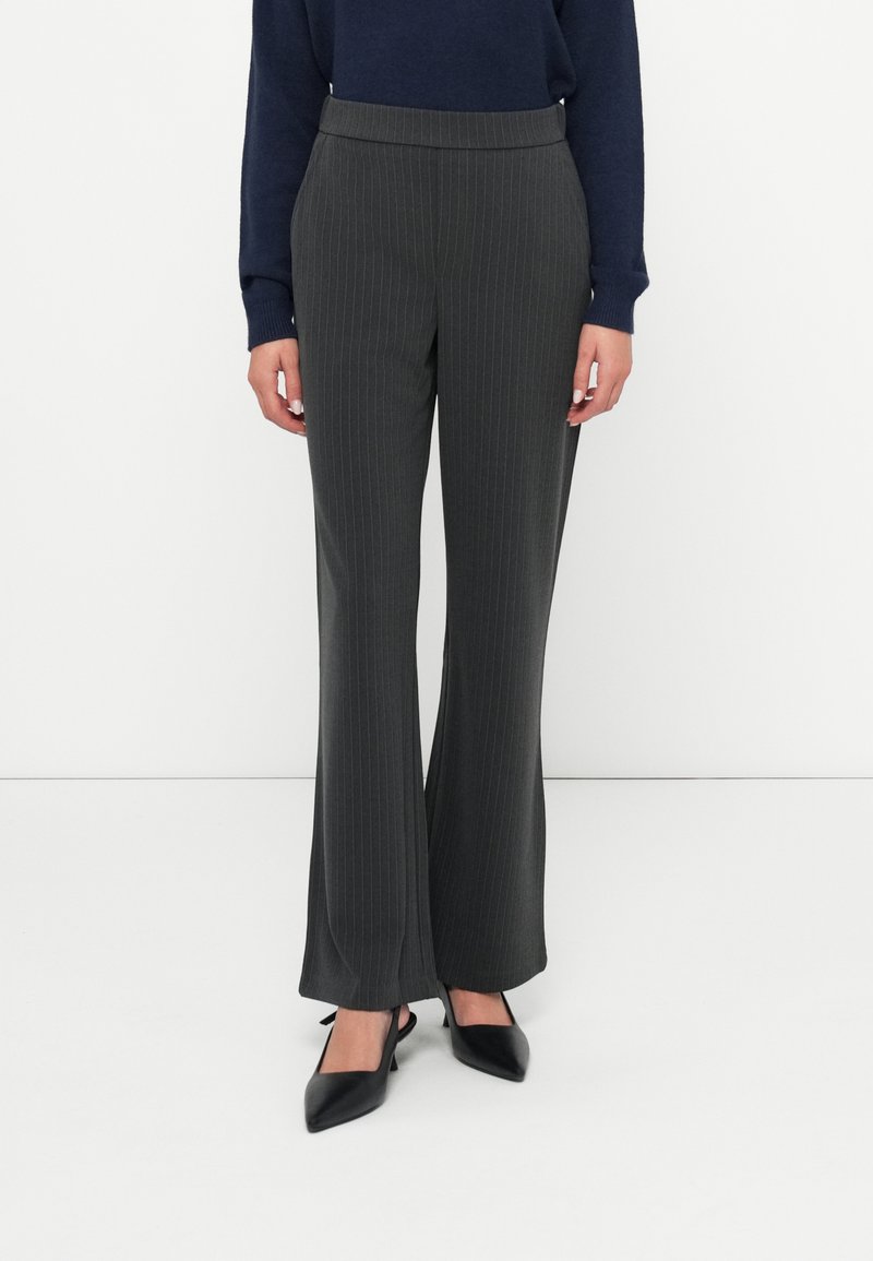 Dark gray pinstripe trousers with a fitted waist, flared legs, and smooth material, paired with pointed black heels.