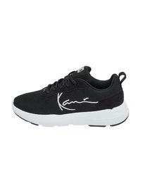 Baskets de sport noires avec une tige en mesh et des accents en daim, semelle blanche, lacets noirs et une signature blanche bien visible sur le côté.
