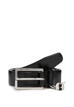 Black leather belt featuring a silver double prong buckle with an engraved logo. Includes a detachable charm with a distinctive design.