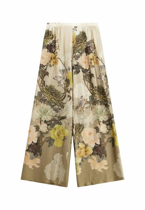 Pantaloni a gamba larga floreali realizzati in tessuto morbido. Presentano grandi motivi floreali gialli, bianchi e verdi su uno sfondo beige. Vita elastica.