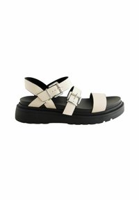 Sandali con cinturini in morbida ecopelle beige chiaro, suola a piattaforma nera, fibbie regolabili in argento e design open toe.