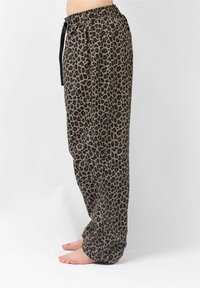 Luipaardprint broeken in bruin en zwarte stof, met een elastische tailleband en een trekkoord voor een verstelbare pasvorm, ontspannen silhouet.