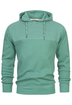 Hanorac verde dintr-un material texturat, cu un model cu nervuri, glugă cu șnur și design cu bloc de culoare solidă pe piept și mâneci.