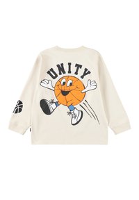 Kreem värvi pikad varrukad T-särk, millel on koomiksist inspireeritud korvpallitegelane kätega ja sõna "ÜHTSUS" üleval, must korvpalliprint vasakul varrukal.