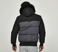 Black and gray puffer jacket with a fur-lined hood, featuring horizontal quilted panels, elastic cuffs, and a rear hang loop.
