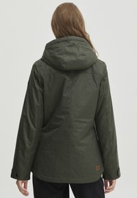 Green, textured jacket with a hood, featuring buttons on the sleeves and a logo patch at the lower back. Designed for warmth and functionality.