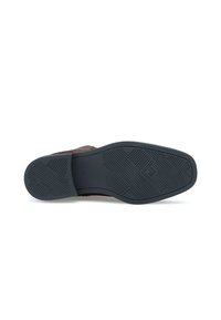 Semelle en cuir marron avec une semelle extérieure en caoutchouc noir texturé, présentant des motifs de crampons géométriques pour une adhérence et une traction optimales.