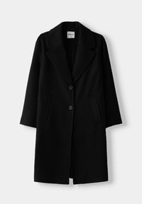 Svart ullrock med slagkrage, två framfickor och två knappar. Har en midjelång design med slät textur.