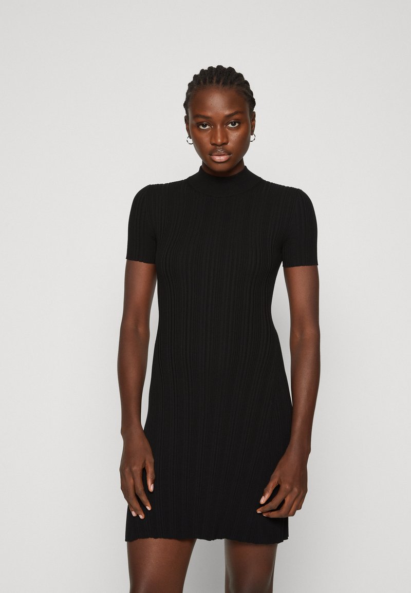 Black ribbed knit dress with short sleeves and a high neckline, featuring a fitted silhouette and a slightly flared hemline.