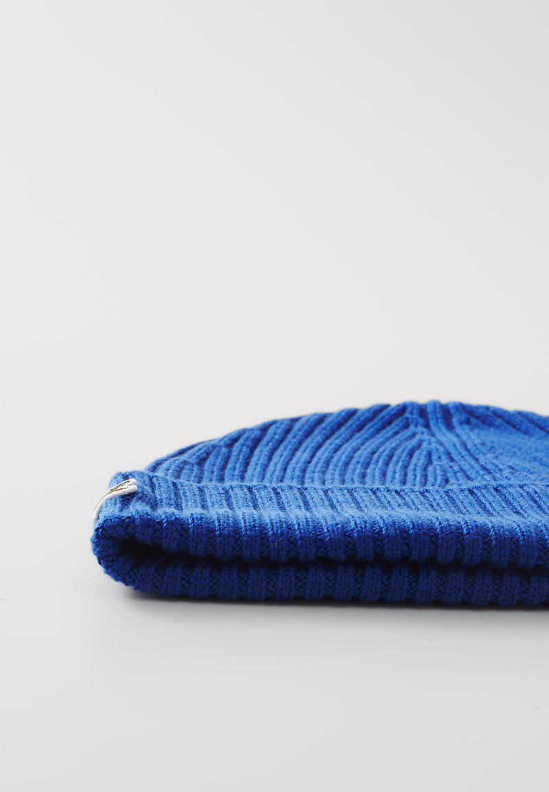 Blauer Strickbeanie mit strukturiertem Rippmuster und umgeschlagenem Saum. Die Oberfläche ist weich, mit einem dezenten Glanz und einem abgerundeten Kronendesign.