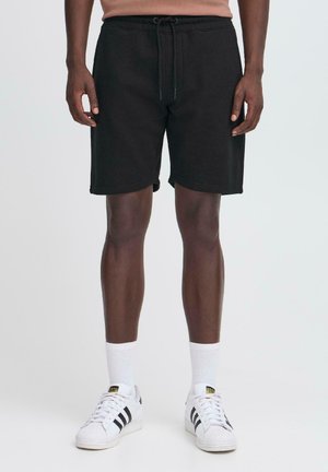 KUNAL - Tracksuit bottoms - black