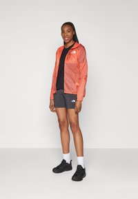 The North Face SHELL - Windbreakers - radiant orange/black