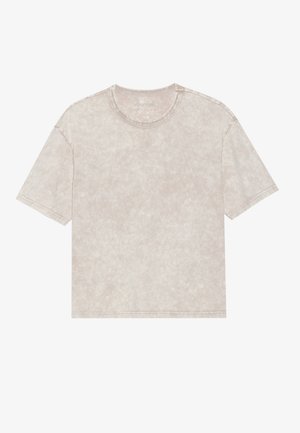 Short-sleeve, crew-neck t-shirt in light beige, made of soft cotton with a textured, slightly washed appearance and subtle tonal variations.